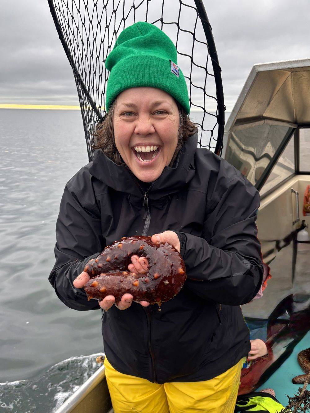 Marina Winterbottom smiling on a boat, holding a crab