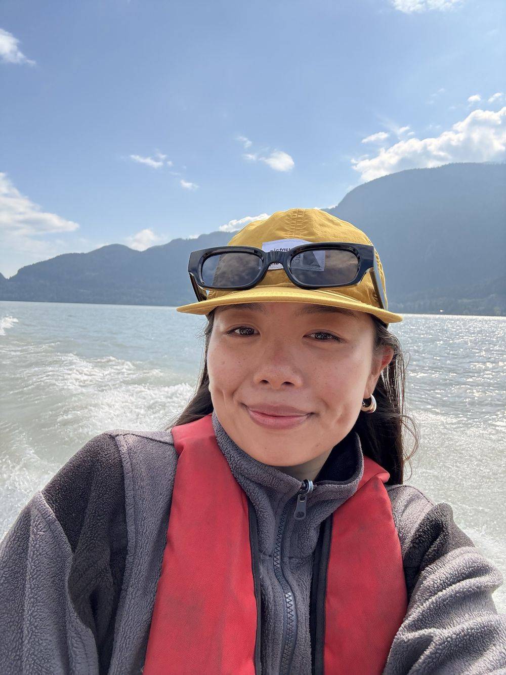 Melanie Man in a life jacket and cap on the water